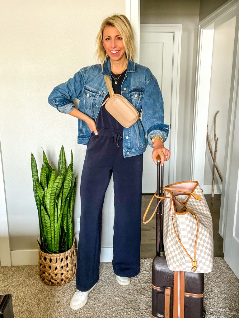 travel outfit idea for spring/summer jumpsuit, denim jacket, sneakers 
