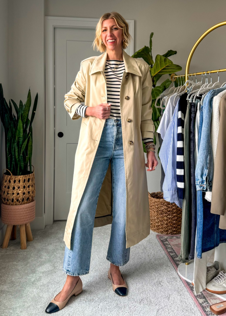 Spring capsule wardrobe outfit with stripe tee, straight leg jeans, trench coat, ballet flats 